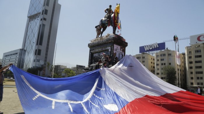 La bandera chilena con un ojo herido que se desplegó en Plaza Italia